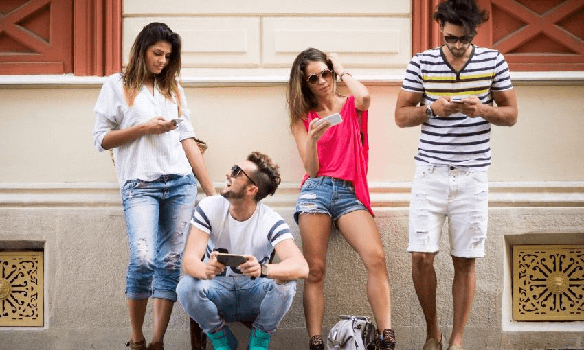 Look, let’s just go with the caption that came with the stock image: Group of four people in the city standing (and one is crouching) next to a building and operatng their mobile phones. Looks like they are testing mobile applications or social media. 
