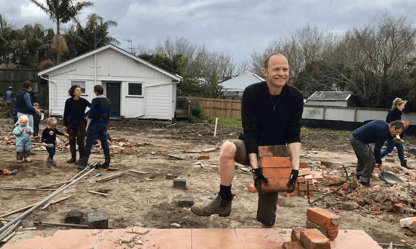 Thom Gill (centre) and neighbours of Cohaus muck in at the site of their future home. Photo: Prue Fea 
