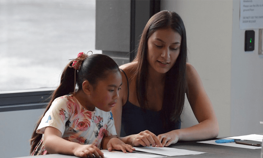 Sarafina Tipene talks to a young girl at the Ka Rikarika a Tane formal dinner. Photo: Supplied. 
