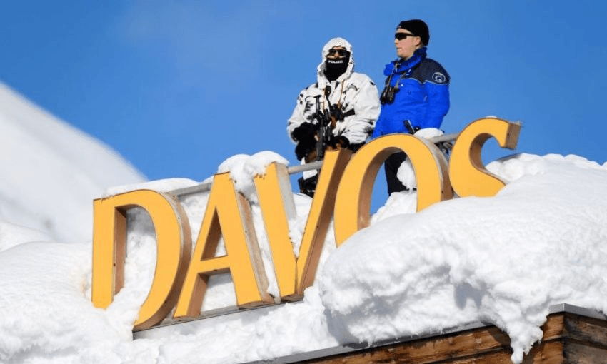 Swiss armed security stand guard on the rooftop of a hotel near the Congress Centre on the opening day of the World Economic Forum in 2018. Photo: FABRICE COFFRINI/AFP via Getty Images 
