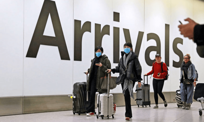 Passengers in the arrivals concourse at Heathrow airport in London. (Photo by Steve Parsons/PA Images via Getty Images) 
