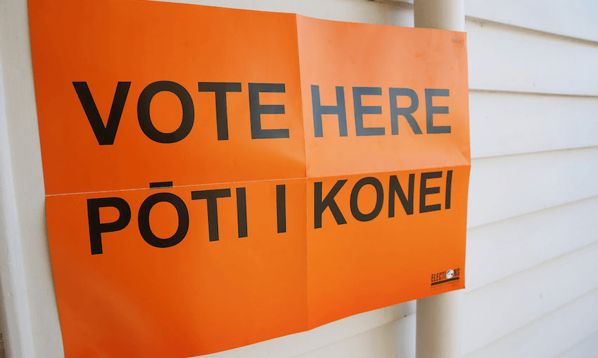 Orange sign that reads Vote here Pōti i konei