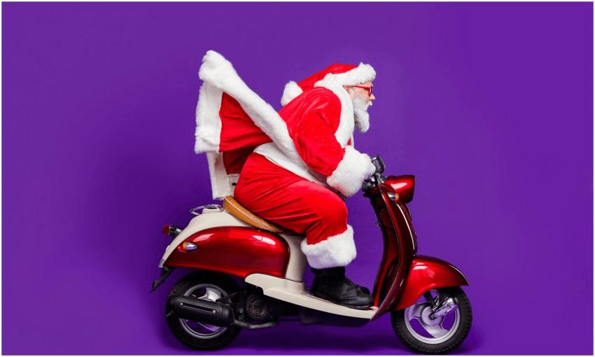 Santa riding a red scooter