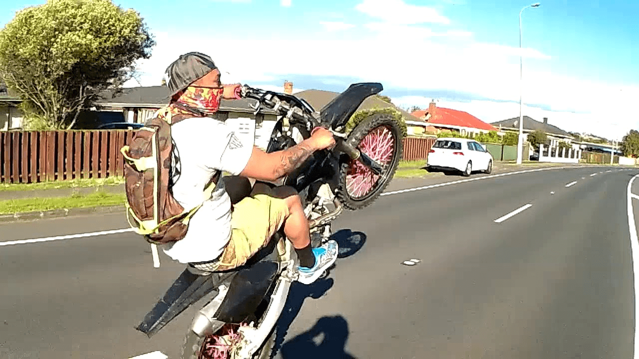 Screenshot of dirt bike rider on a road in Ōtara (Photo: YouTube screenshot of video titled Team Killer Beez) 
