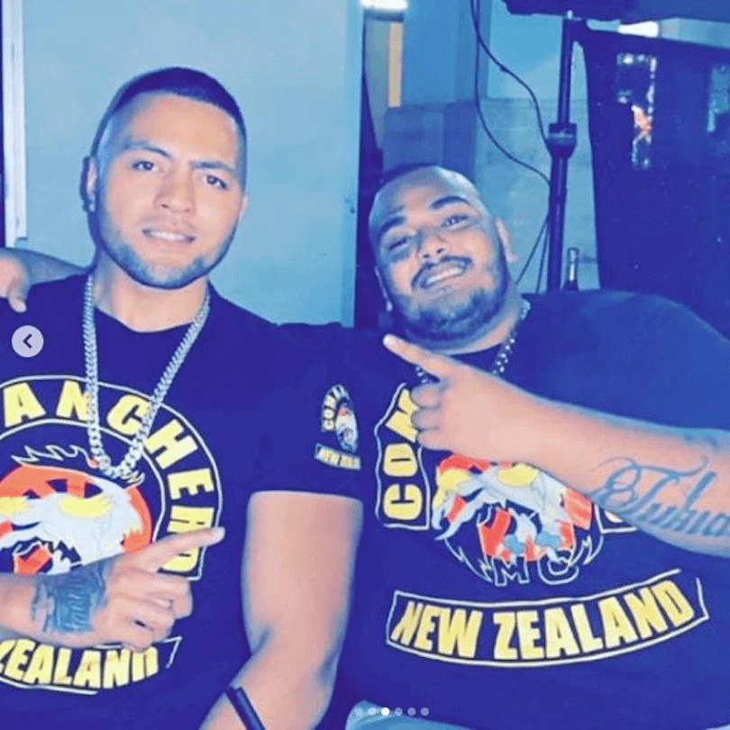 Two young men in Comanchero T shirts smiling at camera